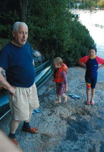 Dad and Lilly and Grace on the rock lakefront Dickie Lake